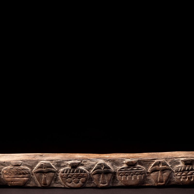 Headrest from Rukai tribe with face and pot patterns - South Taiwan