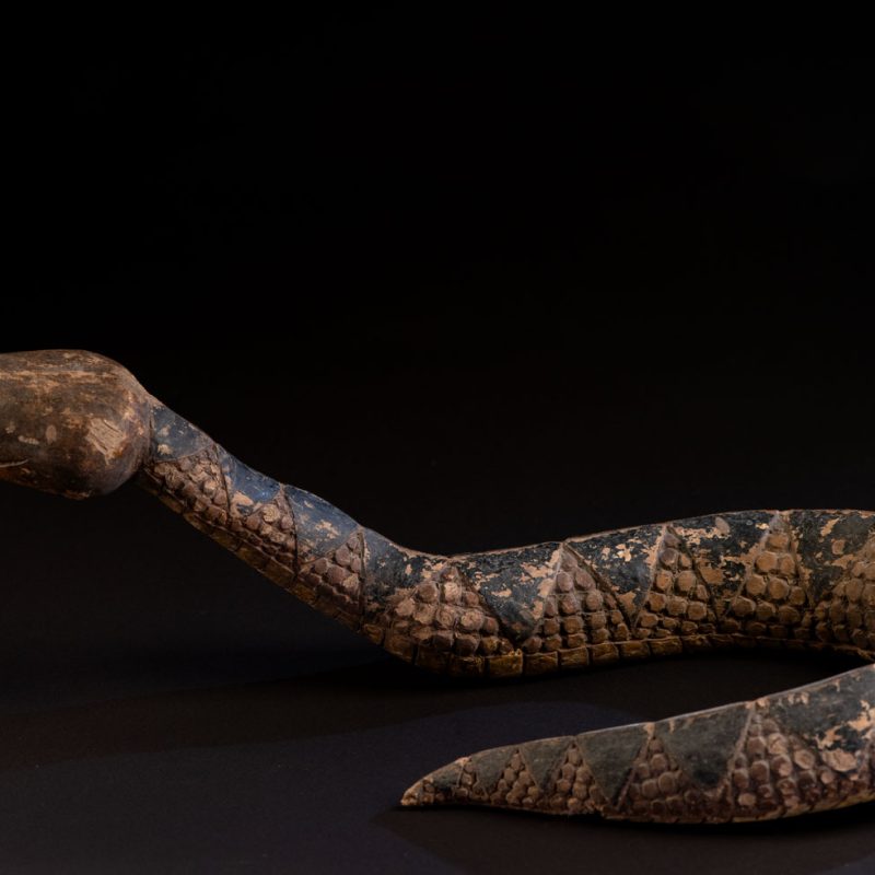 This painted snake sculpture frequently found in Paiwan houses holds a spiritual significance comparable to that of the crucifix for Christians.