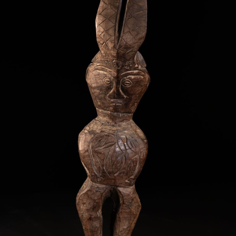 Paiwan tribe Statue depicting a male ancestor wearing a jacket and a ceremonial hat with huge eagle feather, sign of Valor and Vigor.